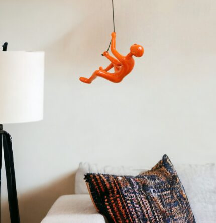6" X 3" Orange Resin Climbing Man Hanging Dimensional Sculpture - Image 1